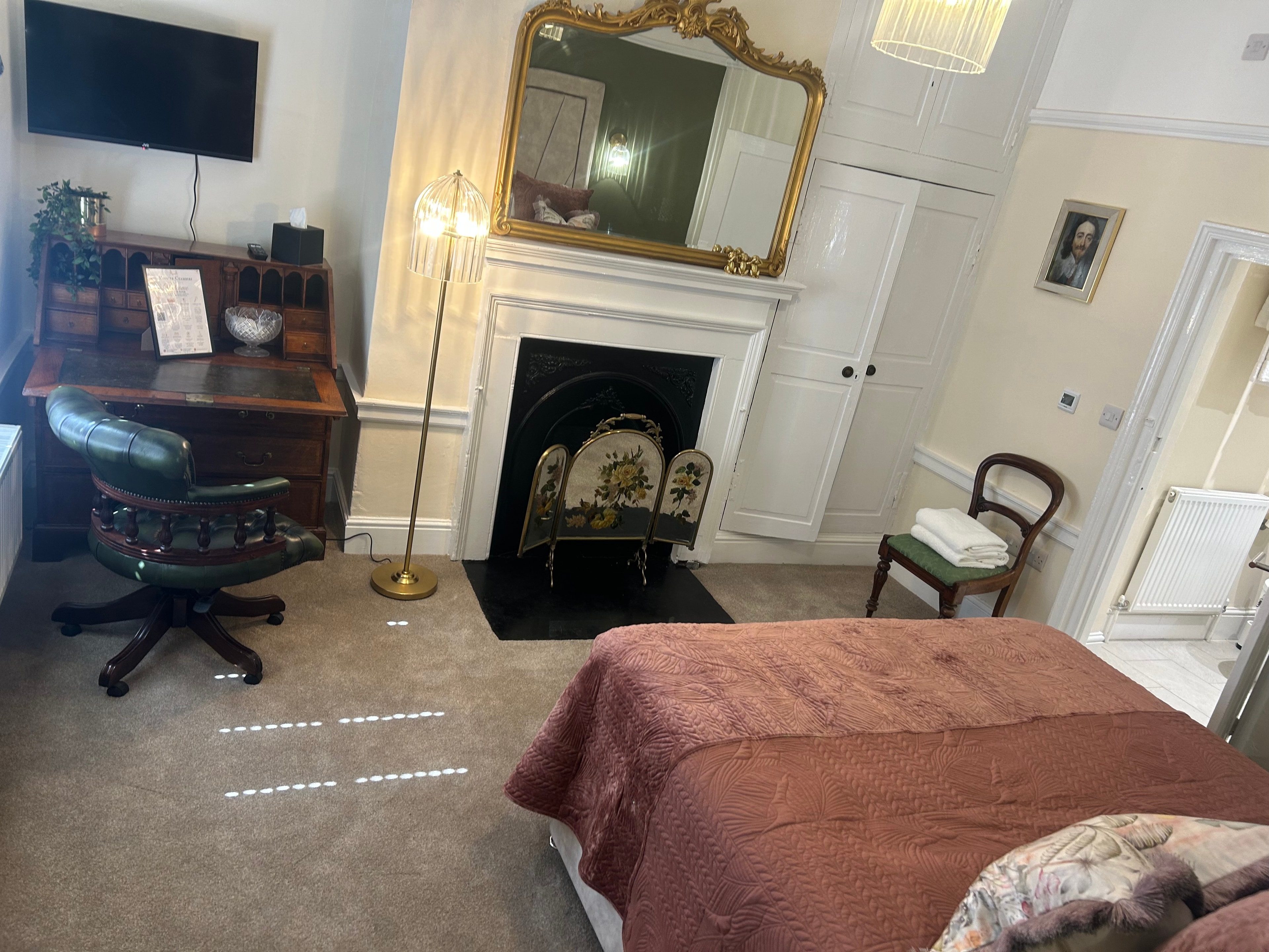 Library Suite — spacious bedroom with original fireplace, gold mirror and antique writing desk